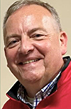 Dr. Stephen Besson wearing a plaid shirt with red pullover